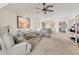 Bright living room featuring comfy sofas, a glass coffee table, and neutral carpeting at 101 Pebble Rock Dr, Venice, FL 34293