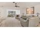 Spacious living room with beige couches and large windows at 101 Pebble Rock Dr, Venice, FL 34293