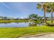 Community pond with lush landscaping and homes around at 101 Pebble Rock Dr, Venice, FL 34293