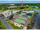 Community view showing tennis courts, pool, and building at 175 Kings Hwy # 233, Punta Gorda, FL 33983