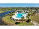 Community pool, tennis courts, and clubhouse with nearby lake at 175 Kings Hwy # 233, Punta Gorda, FL 33983