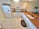 White kitchen with corian countertops and appliances at 175 Kings Hwy # 233, Punta Gorda, FL 33983