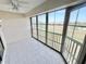 Screened lanai with tile flooring and view of green space at 175 Kings Hwy # 233, Punta Gorda, FL 33983