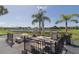 Community patio with tables, grill, and pond views at 175 Kings Hwy # 233, Punta Gorda, FL 33983