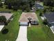 Aerial view showing house, driveway, and front yard at 35 Mark Twain Ln, Rotonda West, FL 33947