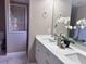 Bathroom features double vanity, shower, and white cabinetry at 35 Mark Twain Ln, Rotonda West, FL 33947