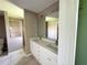 Double vanity bathroom with a shower and toilet at 35 Mark Twain Ln, Rotonda West, FL 33947