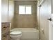 Bathroom with a bathtub, toilet and light brown tile at 35 Mark Twain Ln, Rotonda West, FL 33947