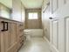 Bathroom with light brown tile, a bathtub and modern vanity at 35 Mark Twain Ln, Rotonda West, FL 33947