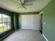 Bright bedroom with tile flooring, ceiling fan, and large window at 35 Mark Twain Ln, Rotonda West, FL 33947