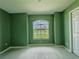 Bedroom with large window and green walls at 35 Mark Twain Ln, Rotonda West, FL 33947