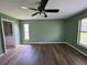 Serene bedroom with light green walls and wood-look floors at 35 Mark Twain Ln, Rotonda West, FL 33947