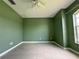 Green-walled bedroom with tile flooring and a ceiling fan at 35 Mark Twain Ln, Rotonda West, FL 33947