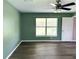 Bedroom with ceiling fan, window, and hardwood floors at 35 Mark Twain Ln, Rotonda West, FL 33947