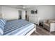 Main bedroom with a white bed frame, blue and white striped bedding, and a dresser at 6000 Boca Grande Cswy # D46, Boca Grande, FL 33921