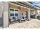 Covered patio with seating area, ceiling fan, and lighting at 7537 Pool Compass Loop, Wesley Chapel, FL 33545