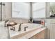 Relaxing bathtub with neutral tile surround and modern fixtures at 7537 Pool Compass Loop, Wesley Chapel, FL 33545