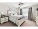 Bright bedroom with a queen-size bed and ceiling fan at 7537 Pool Compass Loop, Wesley Chapel, FL 33545