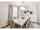 Elegant dining room with a light and airy feel, featuring a modern dining table and chandelier at 7537 Pool Compass Loop, Wesley Chapel, FL 33545