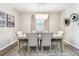 Bright dining room features a large table with seating for six and a beautiful chandelier at 7537 Pool Compass Loop, Wesley Chapel, FL 33545