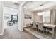 Elegant dining room with chandelier and view of living room at 7537 Pool Compass Loop, Wesley Chapel, FL 33545