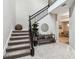 Bright and spacious entryway with staircase and console table at 7537 Pool Compass Loop, Wesley Chapel, FL 33545