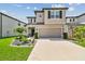 Two-story house with stone accents and landscaped yard at 7537 Pool Compass Loop, Wesley Chapel, FL 33545