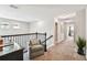 Upstairs hallway with plush carpeting and an inviting sitting area at 7537 Pool Compass Loop, Wesley Chapel, FL 33545