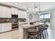 Modern kitchen with stainless steel appliances, granite countertops, and an island at 7537 Pool Compass Loop, Wesley Chapel, FL 33545