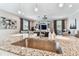 Modern kitchen island with granite countertops and a stylish sink at 7537 Pool Compass Loop, Wesley Chapel, FL 33545