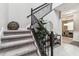 Elegant staircase with dark wood railings and gray carpeting at 7537 Pool Compass Loop, Wesley Chapel, FL 33545