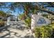 Welcoming entrance to 11000 Placida Harbour with lush landscaping and elegant signage at 11000 Placida Rd # 2303, Placida, FL 33946