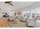 Bright living room with vaulted ceilings, modern fan, dining area and comfortable seating at 11000 Placida Rd # 2303, Placida, FL 33946