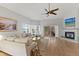 Open living room with a sofa, balcony access, and a cozy fireplace, perfect for relaxing and entertaining at 11000 Placida Rd # 2303, Placida, FL 33946