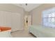 Bedroom featuring two twin beds and large windows with colorful curtains at 26950 Pavin Dr, Englewood, FL 34223