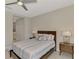 Bedroom featuring neutral colors, ceiling fan, and an en-suite bathroom at 26950 Pavin Dr, Englewood, FL 34223