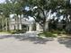 Elegant community clubhouse with a welcoming entrance, set amidst palm trees and manicured landscaping at 26950 Pavin Dr, Englewood, FL 34223