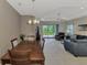Dining area seamlessly connected to the living room with access to the lanai, creating an open and airy space at 26950 Pavin Dr, Englewood, FL 34223