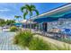 Inviting cafe exterior featuring outdoor seating with blue umbrellas, lush landscaping, and a bright atmosphere for a relaxing experience at 26950 Pavin Dr, Englewood, FL 34223