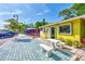 Bright yellow storefront with outdoor seating, showcasing a quaint jewelers shop in a lively downtown area at 26950 Pavin Dr, Englewood, FL 34223