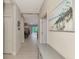 Open hallway with neutral tile floors, an elegant console table, and artwork at 26950 Pavin Dr, Englewood, FL 34223