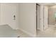 Hallway with views of the laundry room and bathroom and neutral tile flooring at 26950 Pavin Dr, Englewood, FL 34223