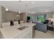 Open-concept kitchen with an island overlooking a dining area and the living room with access to the lanai at 26950 Pavin Dr, Englewood, FL 34223