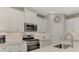 Well-equipped kitchen featuring white cabinets, stainless steel appliances, and modern fixtures at 26950 Pavin Dr, Englewood, FL 34223
