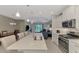 Gourmet kitchen with white cabinets, stainless steel appliances, central island, and adjacent dining area at 26950 Pavin Dr, Englewood, FL 34223