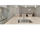 Close-up of a kitchen island with a stainless steel sink, pendant lights, and bar stool seating at 26950 Pavin Dr, Englewood, FL 34223