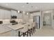 Bright kitchen featuring stainless steel appliances, modern lighting, white cabinets, and an island with bar stool seating at 26950 Pavin Dr, Englewood, FL 34223