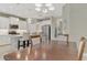 Bright kitchen featuring stainless steel appliances, modern lighting, white cabinets, and an island with bar stool seating at 26950 Pavin Dr, Englewood, FL 34223