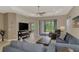 Comfortable living room with a ceiling fan, modern furniture, and an open view to the outside at 26950 Pavin Dr, Englewood, FL 34223