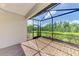 Relax on the screened-in lanai with brick floors, overlooking a beautiful green landscape with manicured shrubbery at 26950 Pavin Dr, Englewood, FL 34223